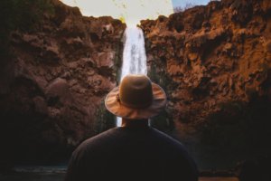 man in front of waterfall