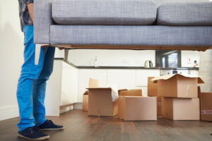 man carrying a couch