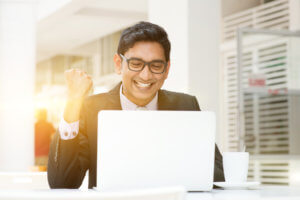 happy employee looking at computer