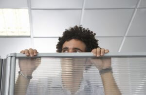 HR manager looking over cubicle for better collaboration