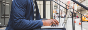 man typing on his computer