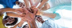 a team putting their hands into a huddle