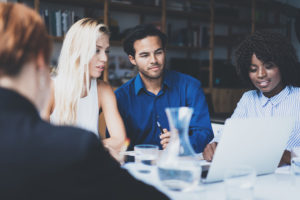 employees talking around a table