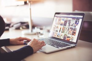 person looking through photos on their computer