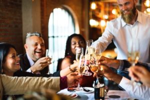 a group of people celebrating with drinks