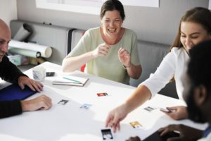 employees playing a game at a table