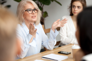 leader training employees at conference table