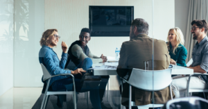 Co workers sitting around table in conference room